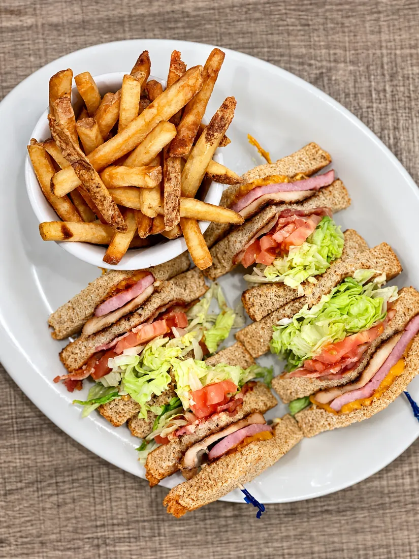 Triple decker club sandwich with fries